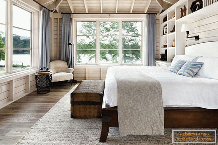 Спална соба во скандинавски стил со голем брачен кревет од дрво во куќата на еден француски бизнисмен.